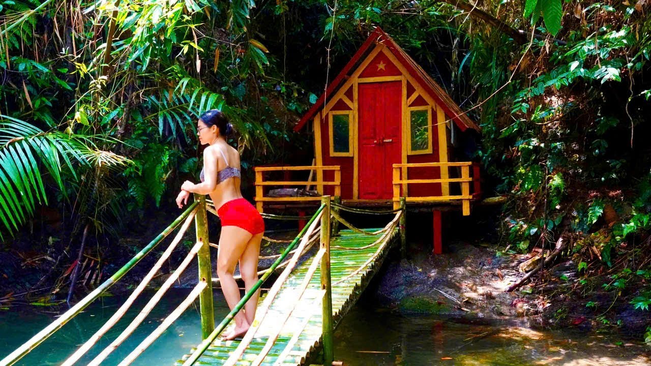 The girl builds a shelter and traps chickens in the rainforest to ...