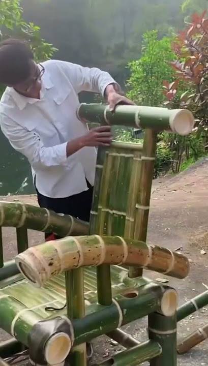 one of the assembly processes of a bench made of bamboo assembled by a male craftsman