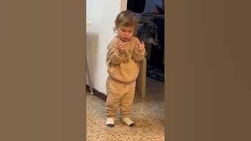 TODDLER LEARNS TO GIVE THUMBS UP