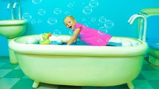 Nastya playing in the playhouse of Peppa toy in the amusement park