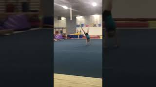 Girl gymnast does several backflips at gym and lands in lawn chair position