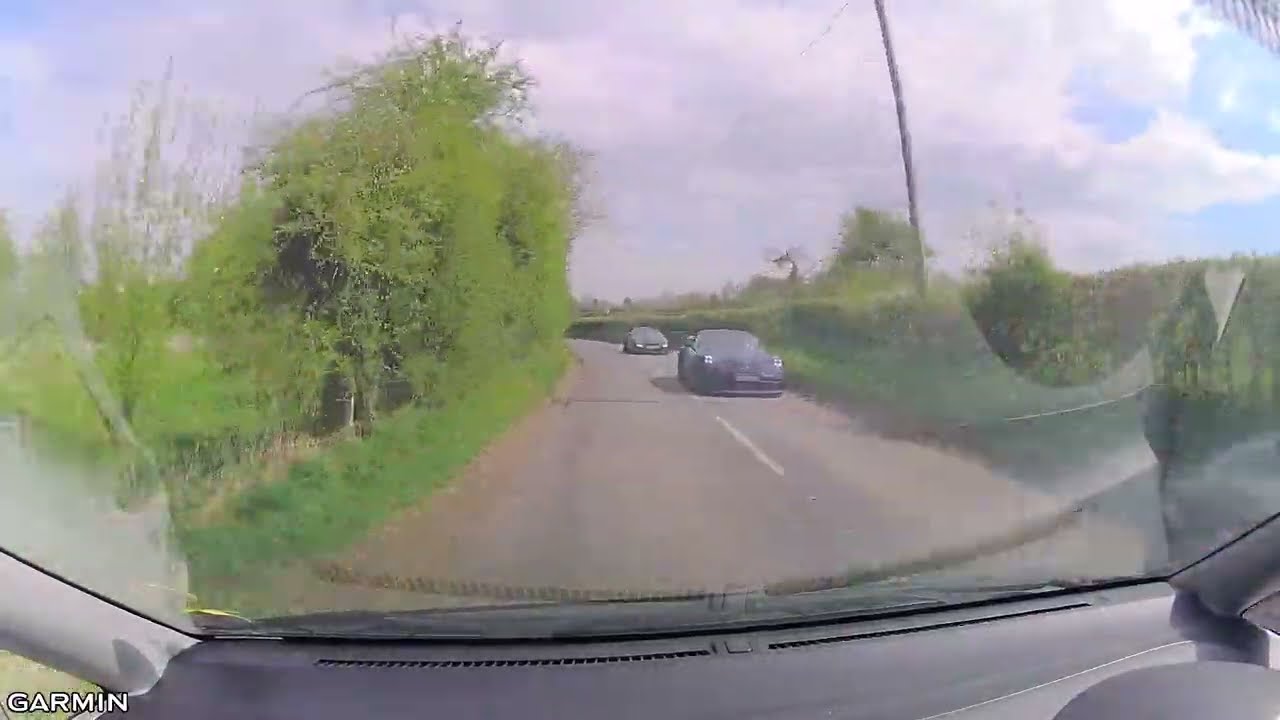 Funny. 11 super cars stuck behind one cyclist on an English Country Road