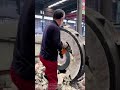 Worker Demolishes Large Abandoned Wheel Hub with Power Tool