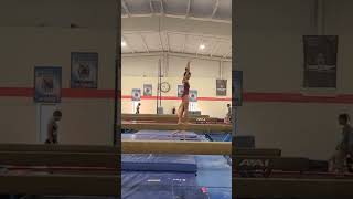 Abby back tuck to split jump on high beam.