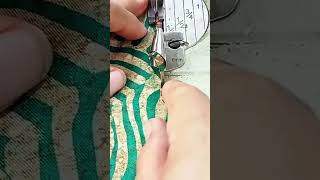 operating industrial sewing machine with binder attachment to fold and stitch edges of batik fabric