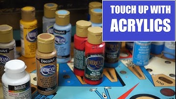 Touching up the playfield on project See Saw using acrylic paints