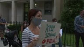 Parents protest school closures in virus spike areas