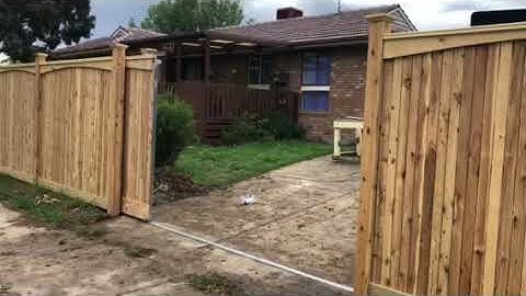 Automatic sliding gate picket fence by Nailed it Fencing