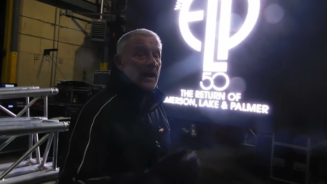 CARL PALMER CHECKING OUT THE VIDEO WALLS BEING USED ON THE RETURN OF