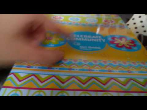 Opening a box of cookies from Girl Guides Singapore
