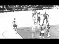 Elgin Baylor hangs and shoots over Nate Thurmond