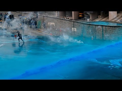 Hong Kong police spray protesters with blue-dye water cannons