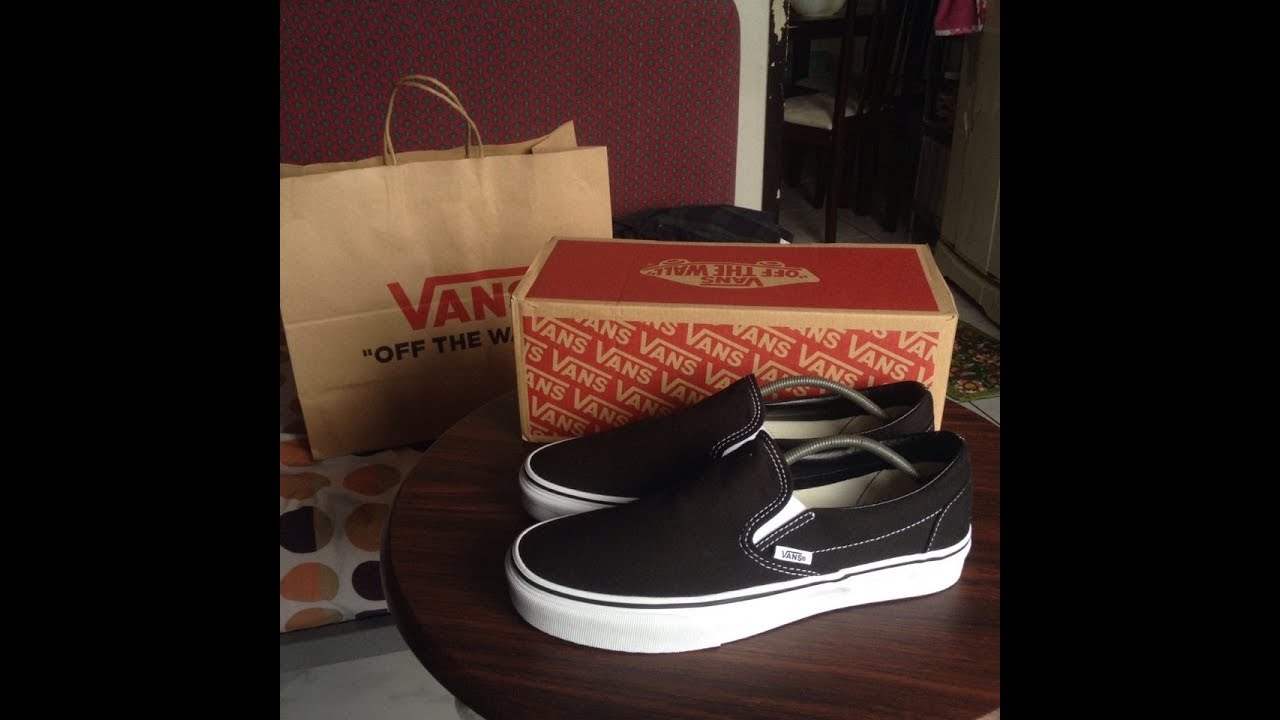 vans slip on black on feet