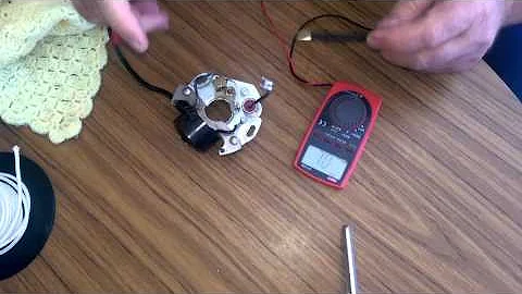 Old Victa ignition magneto testing with multimeter.