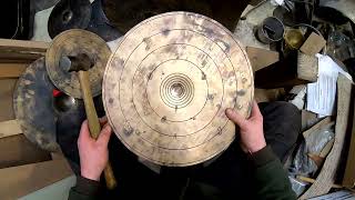Shaping a cymbal cup by hand-hammering