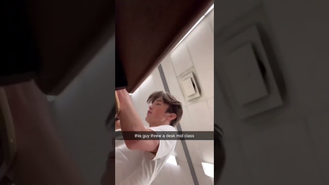 Guy Throws Desk In Class
