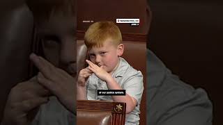 Congressman's son pulls funny faces behind dad during House floor speech
