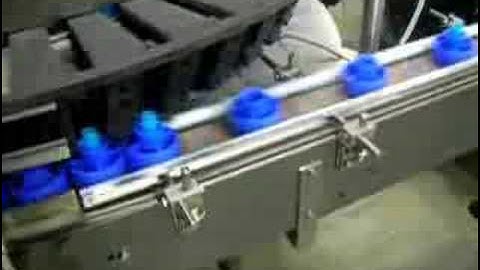 Puck loading of glue sticks, lipstick, or lip balm tubes for filling line & packaging