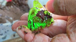 The diamond digger found the green crystal while digging for the sapphire.