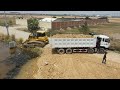 Starting new project heavy dozer working push soil fillingheavy dump truck unloading soil