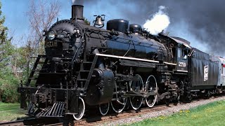 Soo Line 2719 Steam Train
Soo Line 4-6-2 2719 operating on excursions on the Wisconsin Central shortly after its restoration in 1998 and 1999, and a photo special on the Wisconsin-Great Northern Railroad in 2001.
The 2719 was built by Alco in May 1923 as one of six H-23 Pacific types. It became the last steam engine to operate for the Soo Line in 1959. The engine was displayed in Eau Claire, Wisconsin from 1960 to 1996. The Locomotive & Tower Preservation Fund restored the locomotive to operation in 1998 and operated it on various Wisconsin railroads until 2003, once again becoming the last steam engine to operate on the Wisconsin Central. After a few years in storage, the locomotive would be moved to the Lake Superior Railroad Museum in Duluth, MN and operate specials from 2007 to 2013.
Today, the 2719 is awaiting the federally mandated 1472-day inspection, tentatively planned by the current owners of the Lake Superior Railroad Museum.
Footage provided by Jeff Terry, aka Steam Heritage Video. Soo Line 2719 Steam Train