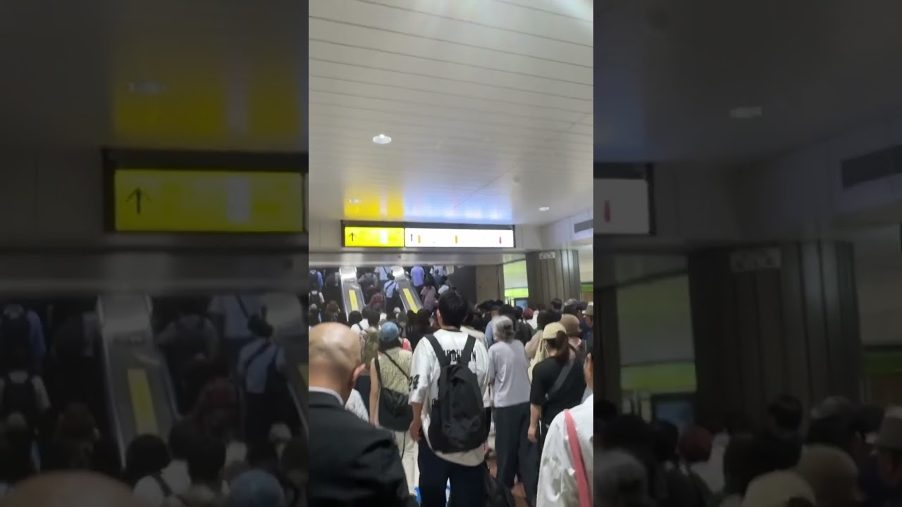 Inside a bustling metro station packed with office workers in the middle of Tokyo