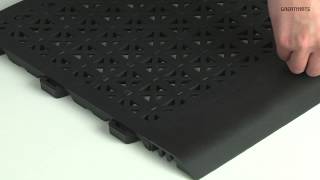 Staylock Tile Perforated Black - Flexible Outdoor Floor Tiles - Shop StayLock Perforated Tiles Now: https://www.greatmats.com/tiles/decking-tiles-black.php
Call 877-822-6622 for live help!

Welcome to Greatmats.com where you can expect great service!

This is our Perforated StayLock Tile in Black.

This flexible PVC floor tile is 1x1 feet in size and offers 9/16 inch of cushion over hard indoor or outdoor surfaces.

Among its best features is its ability to be installed over slightly uneven ground or floors through the use of an active locking connector system. It also has a quick draining slip resistant surface and will not absorb liquids.

Optional ramped border strips sold separately.

Use these tiles anywhere moisture is present:
- Pool Decking
- Patios
- Flat Roofs
- Playgrounds
- Daycares
- Hot Tub Surrounds
- Locker Rooms
- Shower Stalls
- Basements
and much more!

#GreatOutdoorFlooring