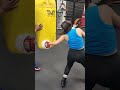 Floyd mayweather sr instructs young lady on heavy bag