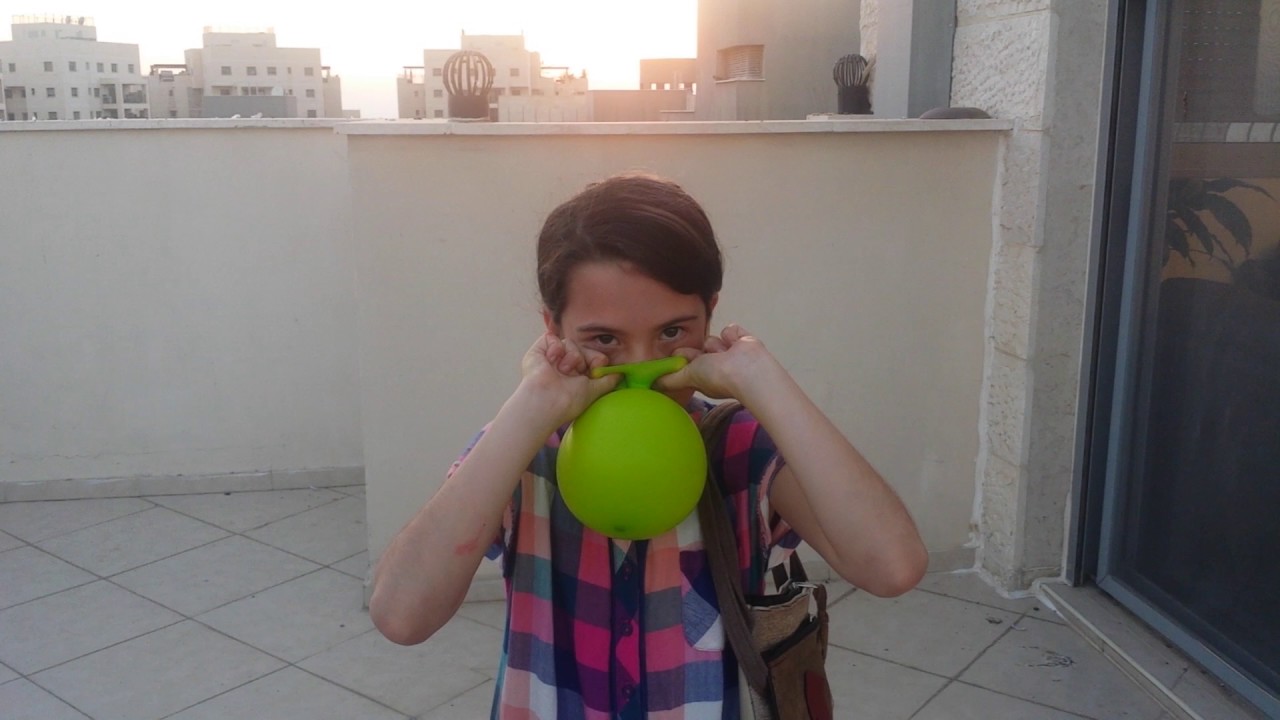 Woman Inflates A Balloon And Sits On It