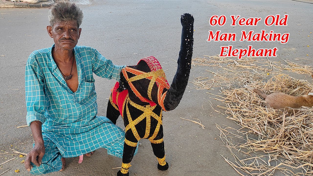 60 year man and his family making elephants from dry grass on road