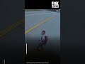 SUV races past stopped bus