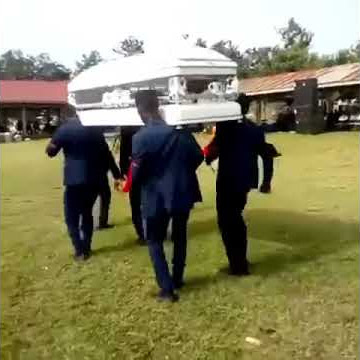 African guys drop coffin while dancing