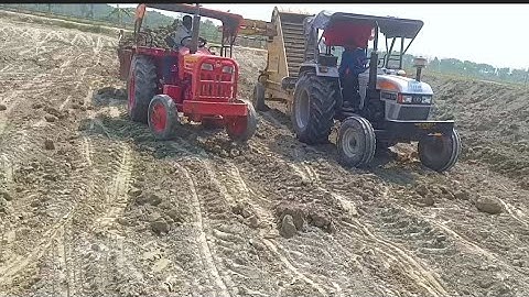 Eicher 557 Tractor loading soil in Mahindra Tractor Trolley using by land leveler