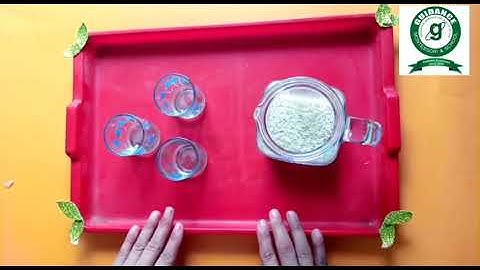 Montessori exercise: pouring rice from jug to glass