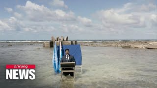 Tuvalu’s foreign minister makes climate speech knee-deep in ocean