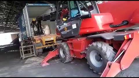 Unloading bag from Container with Manitou Rotating Telehandler