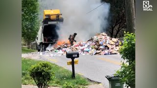 Firefighter tries to douse load of burning garbage on York County road