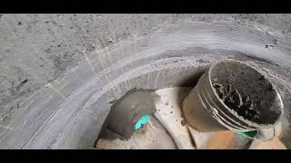 Cementing an 8 inch sewer pipe in a manhole.