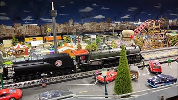 MTH GN 4-8-4 S2 pulling passenger train while Roller Coaster works at Corner Field Model Railroad