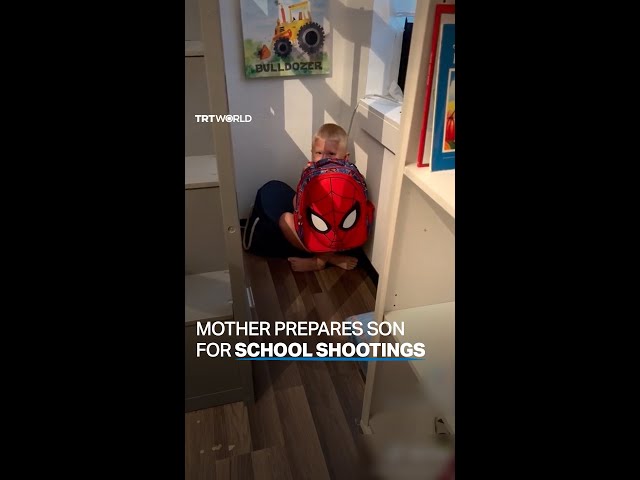 US mother shows son what to do during a school shooting class=
