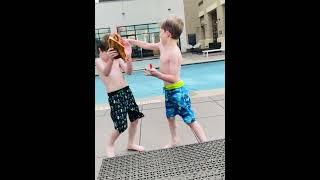 Boys have food fight with slices of pizza near the pool
