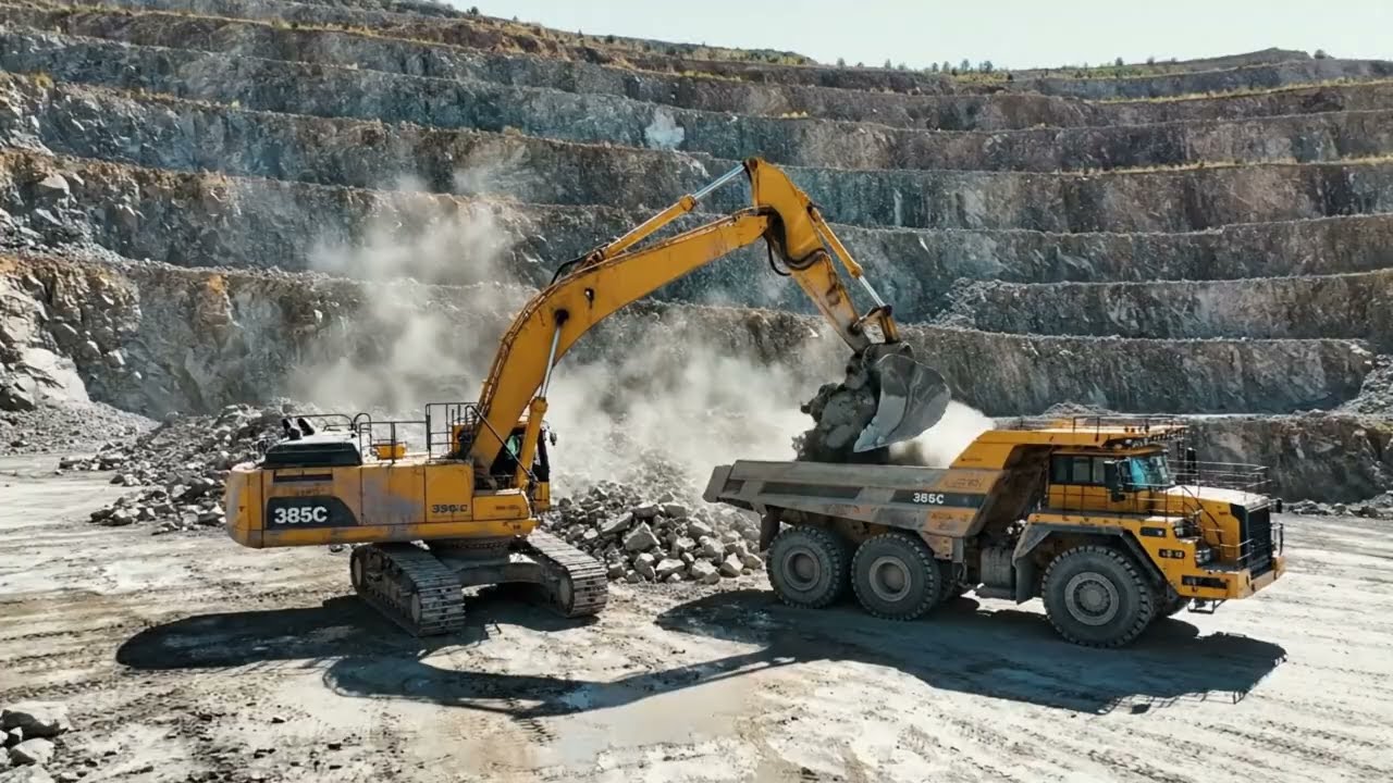 Caterpillar 385C Excavators Loading Trucks at Massive Quarry Operations.