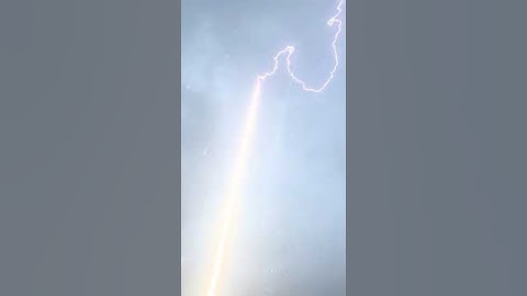 Lightning Bolt Is Guided To Ground Through Rocket Trail