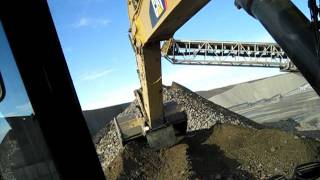 Cat 345DL Excavator Climbing Stockpile