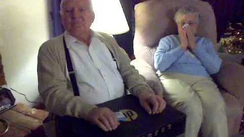 Grandma and grandpa fizet opening christmas gift