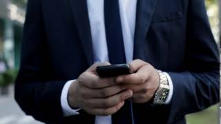 close up of mans hands holding modern smartphone businessman walking while typing on his