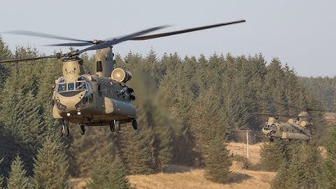 Two Chinooks use forest cover, to infiltrate enemy lines during electronic ware fare training.