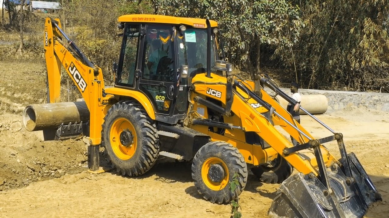 JCB Backhoe Lifting Heavy Culvert Pipe and Installing in Drain - JCB Machine Working