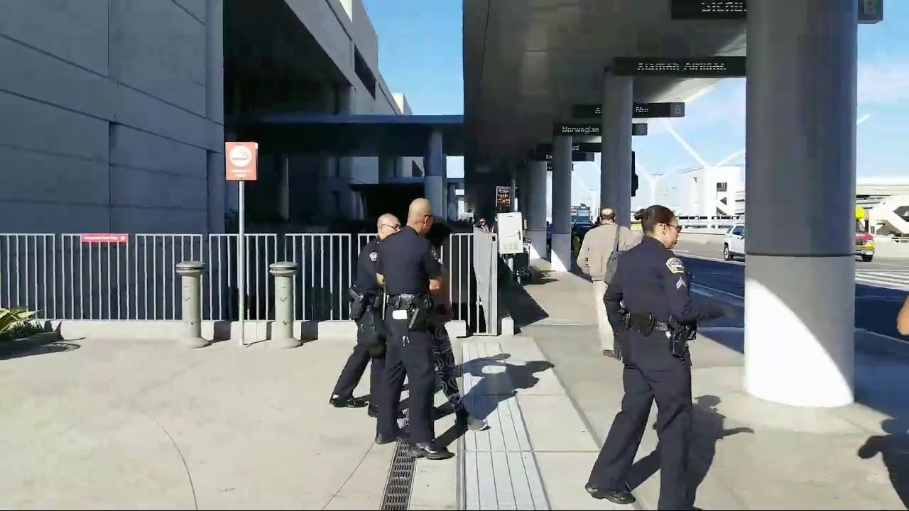 lax airport police arresting a 5150 woman at Los Angeles International ...