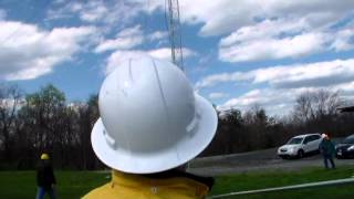 Falling derrick tilt up technique to raise antenna tower